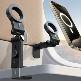 Airplane seat phone holder with smartphone attached.