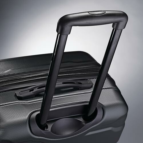 Close-up of a black suitcase handle with an extendable telescopic design.