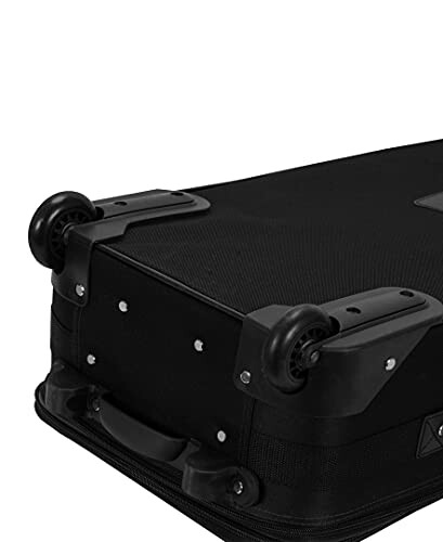 Close-up of a black suitcase with wheels