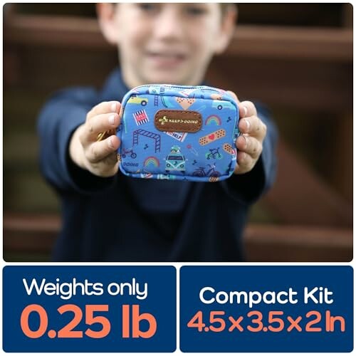 Child holding a small, blue compact first aid kit.