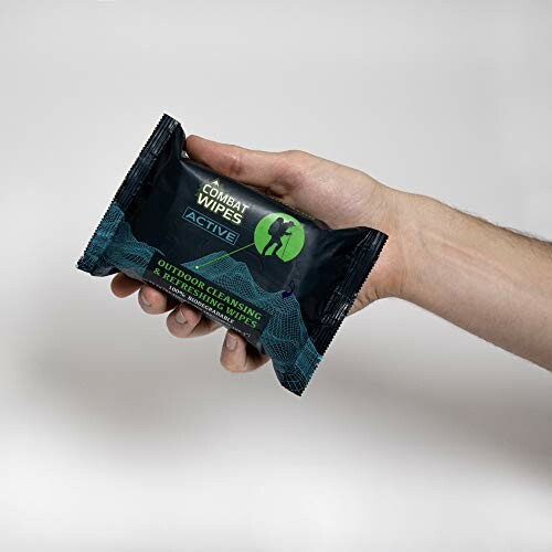 Hand holding a pack of Combat Wipes Active.