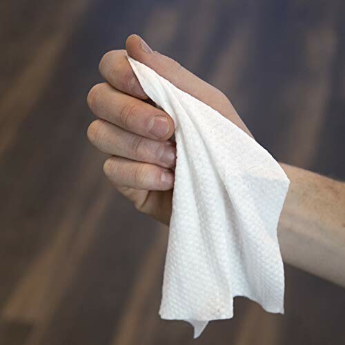 Hand holding a white cloth