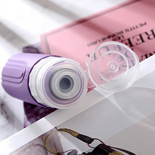 Purple handheld vacuum sealer with open cap