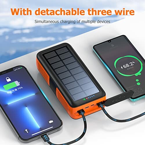 Solar power bank charging two smartphones simultaneously.