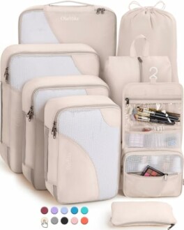 Set of beige travel packing cubes with various sizes and a toiletry bag.