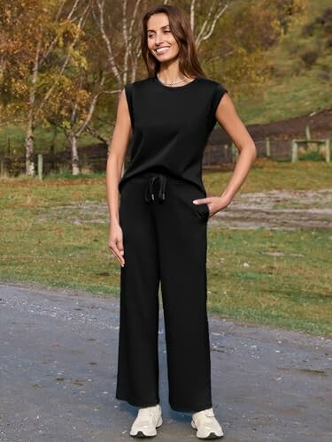 Woman wearing a black outfit standing outdoors