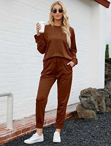 Woman in brown tracksuit holding a cup