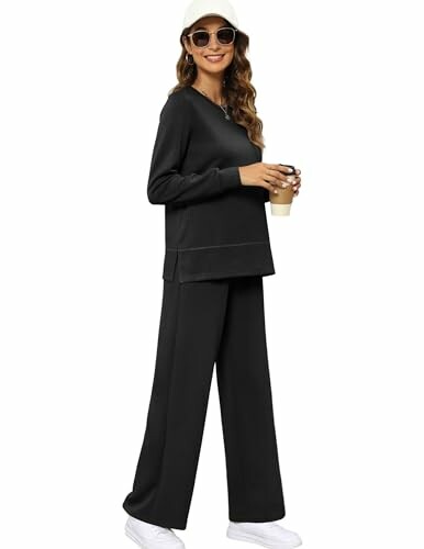 Woman in black loungewear holding a coffee cup